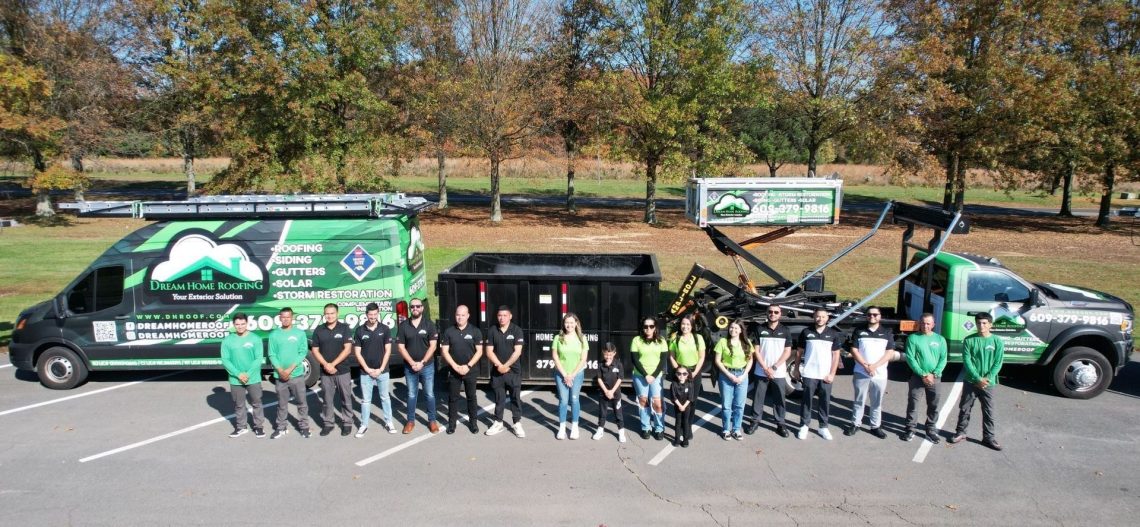 Team photo of Dream Home Roofing crew standing in front of branded company trucks in Sicklerville, NJ.